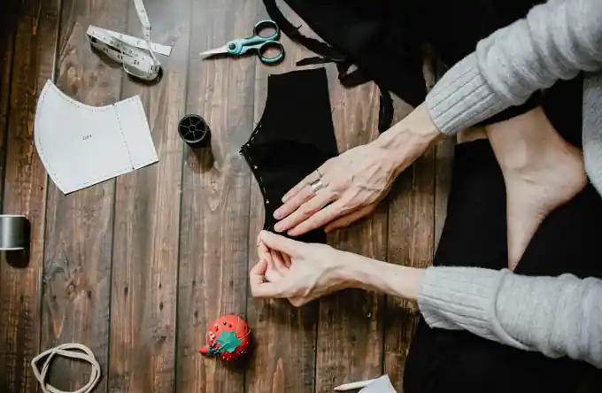 Sewing and fabric pattern making at a crafting table